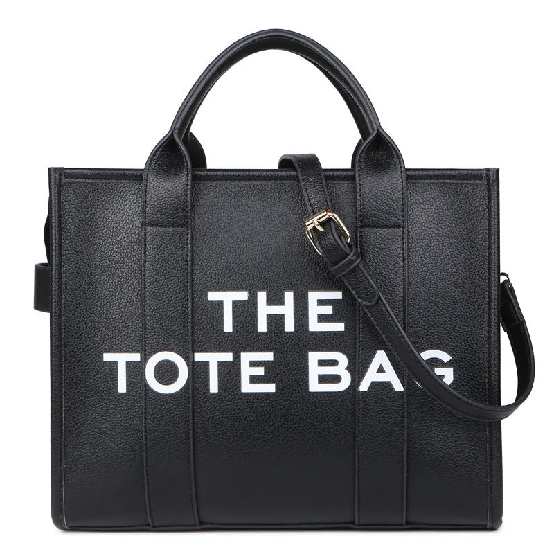Sac cabas de luxe noir designer avec quincaillerie dorée, vue de face.