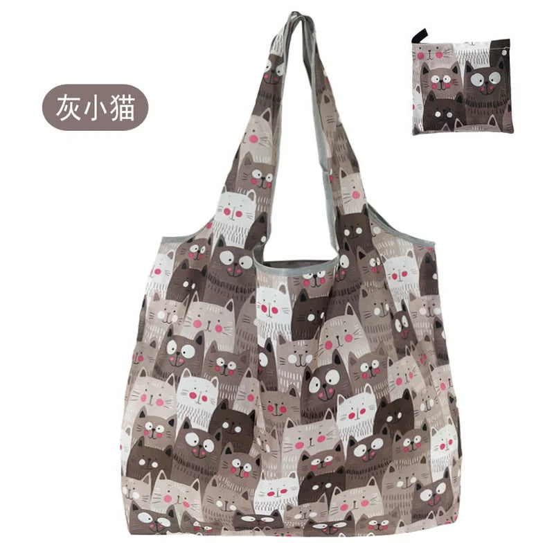 A patterned tote bag featuring a repeating design of cats in various shades of gray and brown.