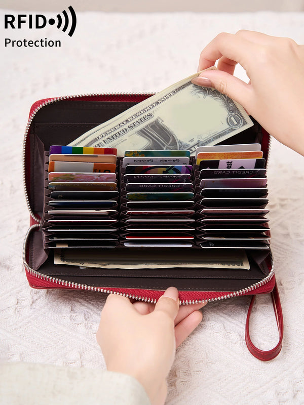 A red wallet with a zipper closure is shown open, displaying various cards and cash protected by RFID shielding.