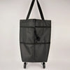 A black foldable grocery and shopping cart with black handles, shown from the front.
