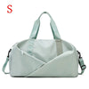 A light mint green nylon duffel bag with light gray straps and a diagonal fold design.