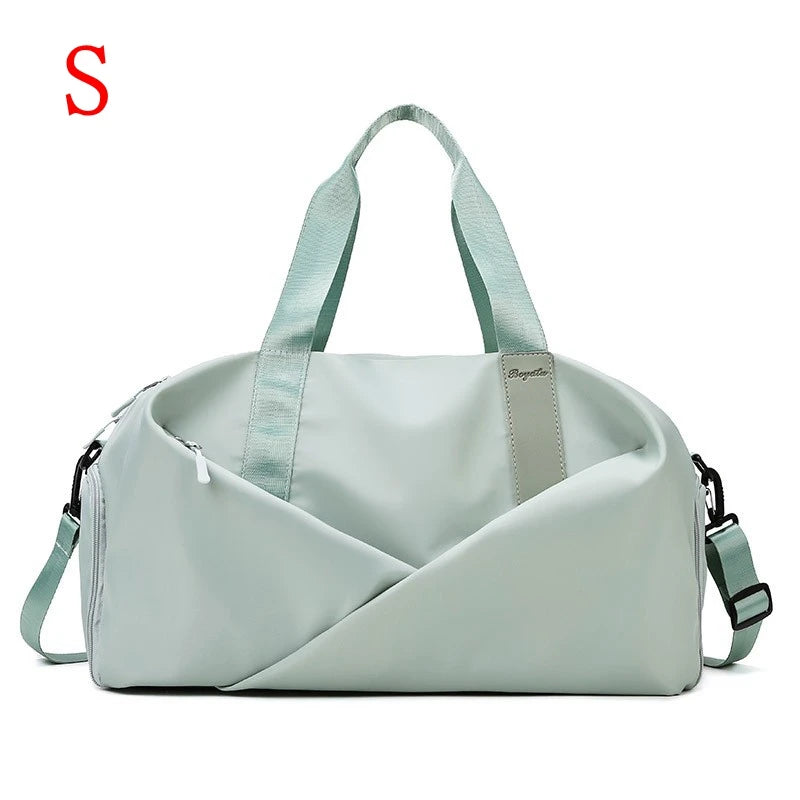 A light mint green nylon duffel bag with light gray straps and a diagonal fold design.