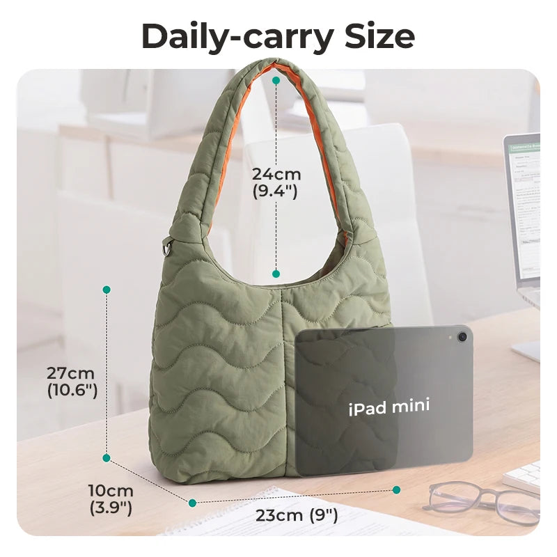 A daily-carry size quilted green nylon shoulder bag shown next to an iPad mini for scale.