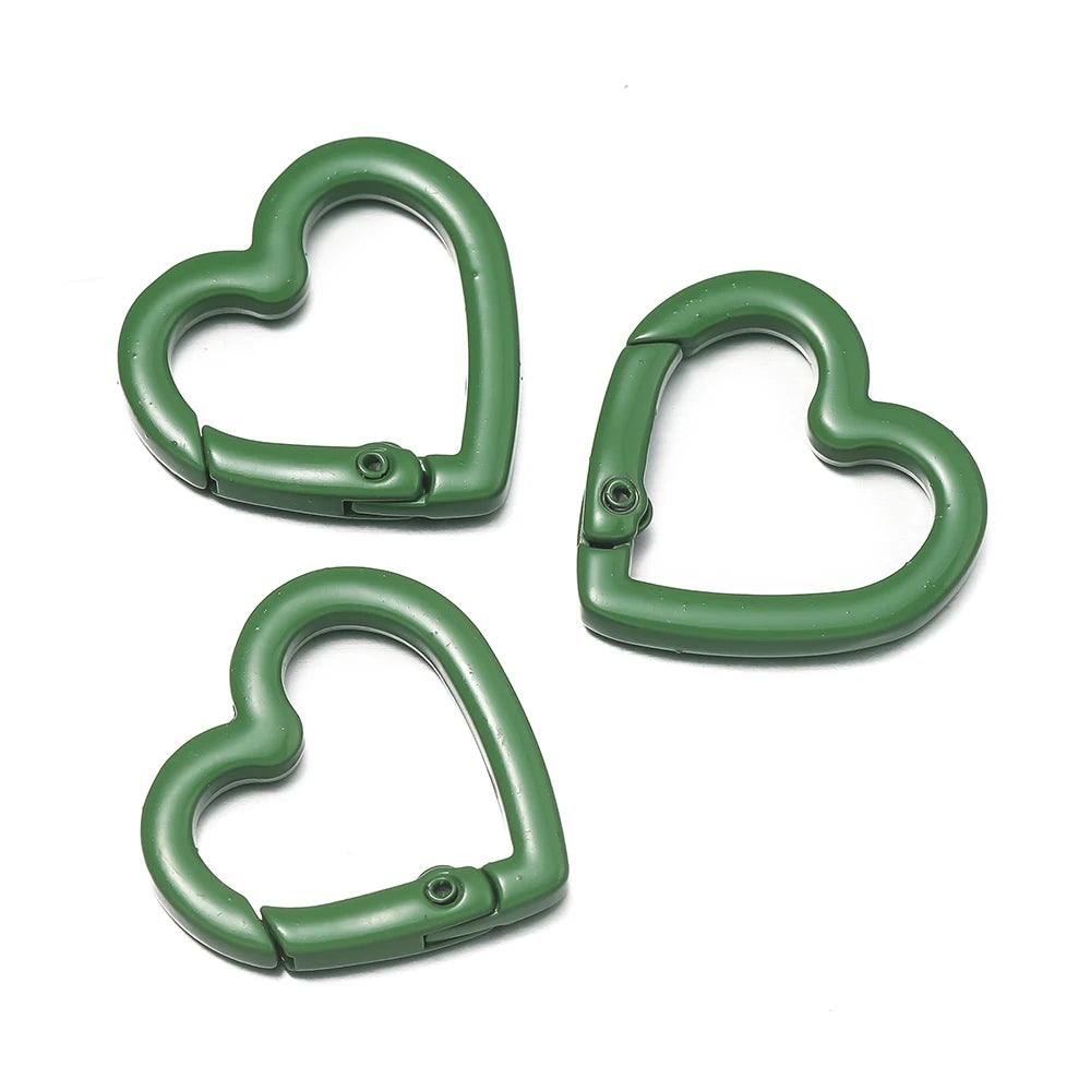 Three heart-shaped metal spring clasps in a dark green color for DIY jewelry and keychains