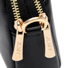 Close-up of a black PU leather trendy shoulder crossbody bag featuring gold-toned zippers and hardware.