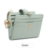 A light mint green minimalist wallet with a leather strap and gold chain detail.