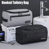 A gray hooked toiletry bag and a black hooked toiletry bag are shown next to a sink.