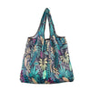 A reusable tote bag made of patterned, teal and green nylon fabric.