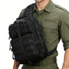 A person wearing a olive green shirt is carrying a black multi-compartment crossbody and chest bag.