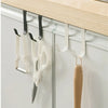 A white heavy duty multi-purpose hook rack for cabinet doors is mounted on a light wood shelf.