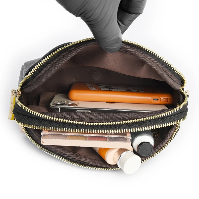 A hand is opening a brown PU leather trendy shoulder crossbody bag revealing a smartphone and some small items inside.