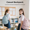 A young woman in a school uniform is shown carrying a pink backpack while standing near desks.
