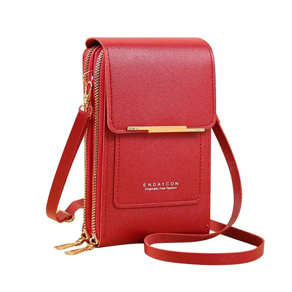 A red leather crossbody bag with a gold zipper and strap.