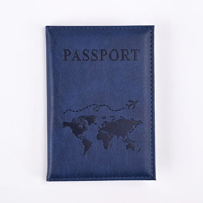 A dark blue leather passport holder with the word PASSPORT and a world map design embossed on it.