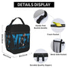A black vintage print lunch bag with various features like a buckle handle, front pocket, mesh side pocket, and durable zippe