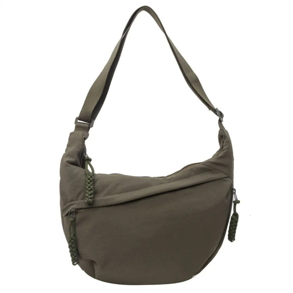A olive green canvas crossbody shoulder bag with a drawstring closure.