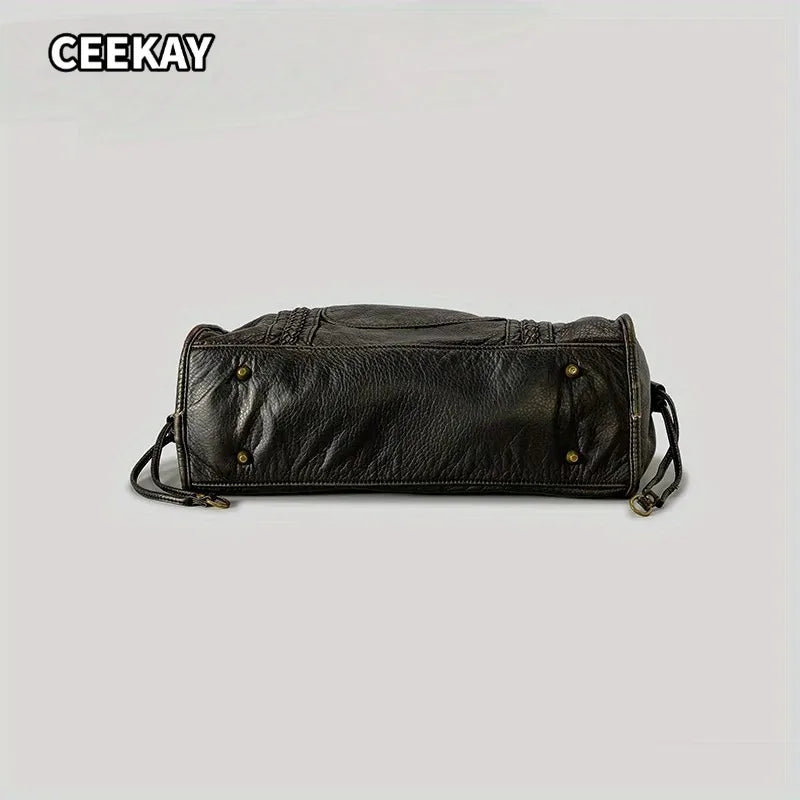 A dark brown vintage washed leather tote bag shown from the side.
