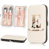 A beige cosmetic case holds a stainless steel nail clipper set with various tools and an embossed letter E and name.