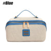 A beige and blue large capacity travel toiletry bag with a handle and zipper closure.