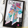 A colorful silky twill ribbon scarf featuring various patterns and colors displayed in a framed picture.