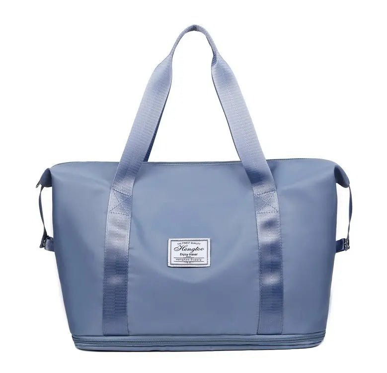 A light blue expandable travel organizer bag with padded straps and a zippered closure.