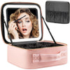 A pink LED lighted makeup train case with adjustable dividers is shown open, displaying a woman's face.