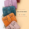 A collection of five retro oil wax wallets in various colors including black, red, purple, teal, and orange.