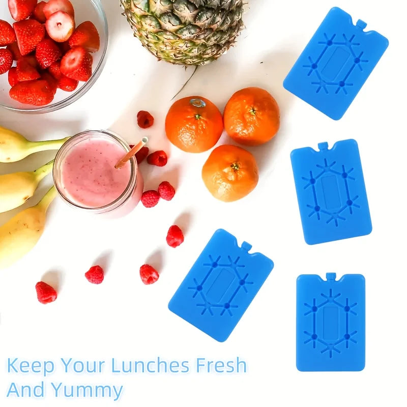 Blaue wiederverwendbare Kühlpacks zum Frische und Geschmack von Mittagessen, gezeigt neben Obst.