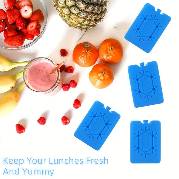 Blaue wiederverwendbare Kühlpacks zum Frische und Geschmack von Mittagessen, gezeigt neben Obst.