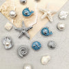 Silver and blue conch-shaped shoe charms and pearl beads displayed on a light background.