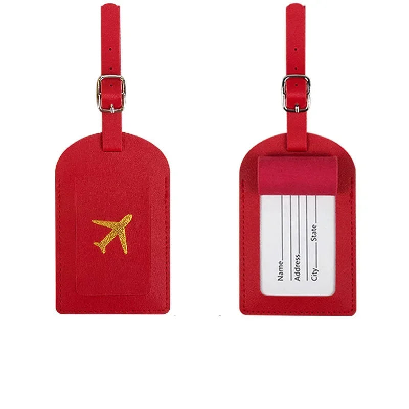 Two red PU leather luggage tags with silver clasps and a gold airplane emblem.