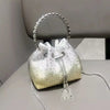 A small, pearlescent clutch bag embellished with crystals and featuring a silver chain strap.