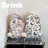 A white backpack featuring a colorful butterfly pattern is displayed on a shelf.