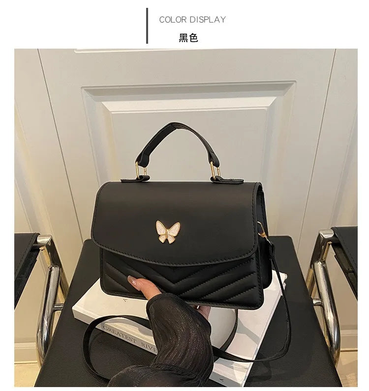 A black women's solid texture shoulder messenger bag is displayed on a dark surface.