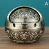 A vintage metal ashtray with a rose embossing on the lid and base, shown against a teal background.