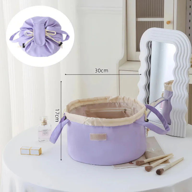 A purple instant-open flat lay makeup organizer bag with a drawstring closure and a mirror in the background.