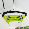 A neon green holographic sequin waist bag with a black adjustable strap resting on a white surface next to a smartphone and p