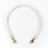 A white leather strap with gold metal buckles, used as replacement handles for a bag.