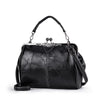 A black leather crossbody shoulder bag with a silver-toned chain and decorative clasp.