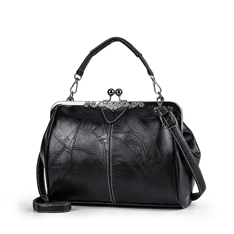 A black leather crossbody shoulder bag with a silver-toned chain and decorative clasp.