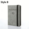 A grey leather passport holder with a black trim and an airplane icon embossed on the cover.