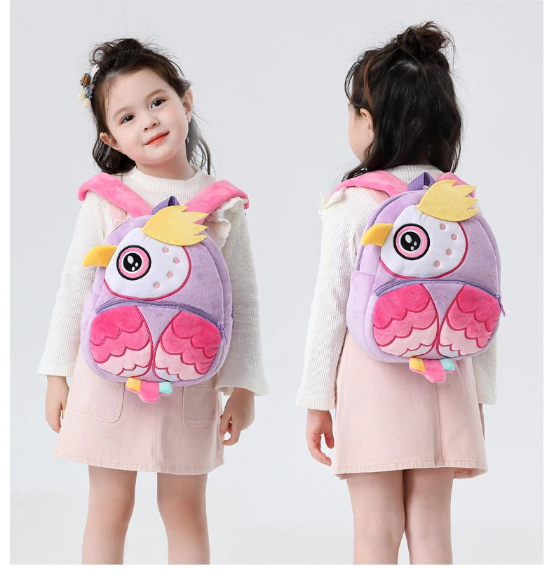 A young girl is shown holding a purple and pink cartoon animal plush backpack for kids.