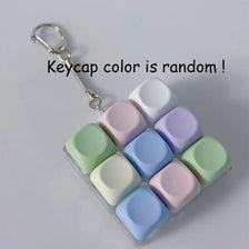 A set of colorful LED macaron-shaped keycaps for a fidget keyboard keychain.