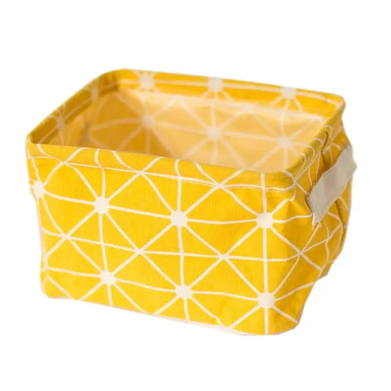 A bright yellow waterproof cotton linen storage basket with a white geometric pattern.