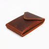 A brown genuine cowhide leather wallet folded and displayed on a white background.