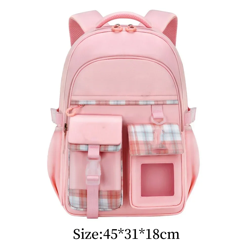 A pink lightweight children's school backpack with plaid accents and a carrying strap.