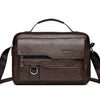 A brown faux leather crossbody bag with a top handle and adjustable strap.