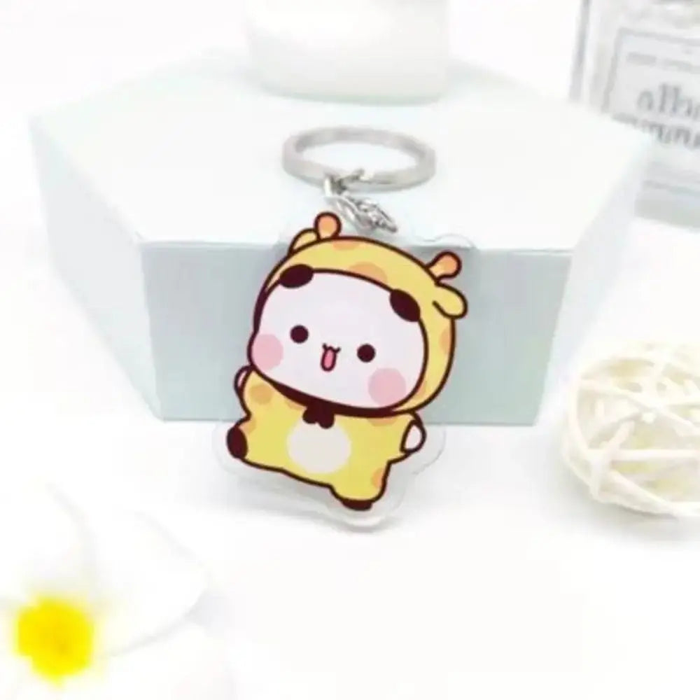 A yellow cartoon character keychain charm is displayed on a white box with a silver keyring.