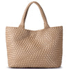 A beige handwoven vegan leather tote bag with a woven texture and a long handle.