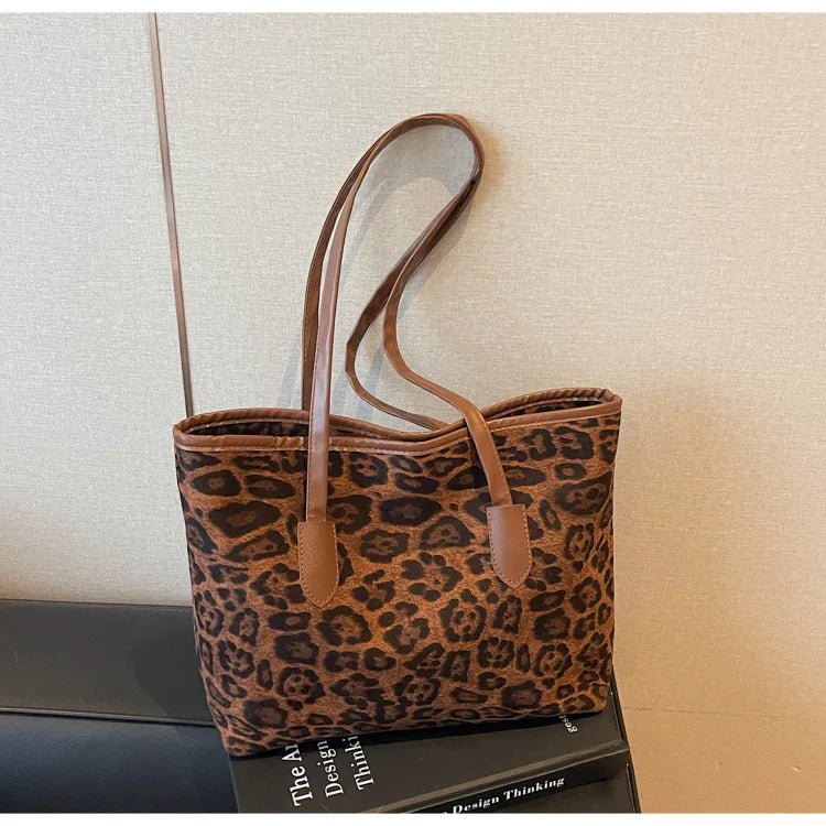 A brown leopard print vintage tote bag with leather handles displayed against a light background.